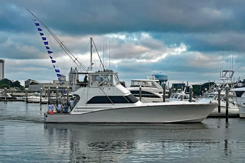Euphoria Yacht Photos Pics Custom Carolina Precision Sportfish 2000 yacht docked at marina under cloudy sky.