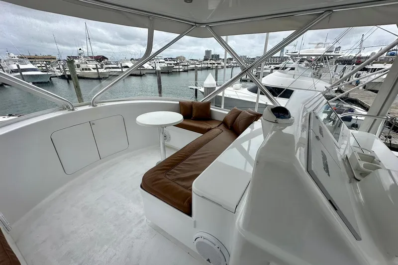 Euphoria Yacht Photos Pics Luxurious 2000 Custom Carolina Precision Sportfish yacht interior with leather seating and marina view.