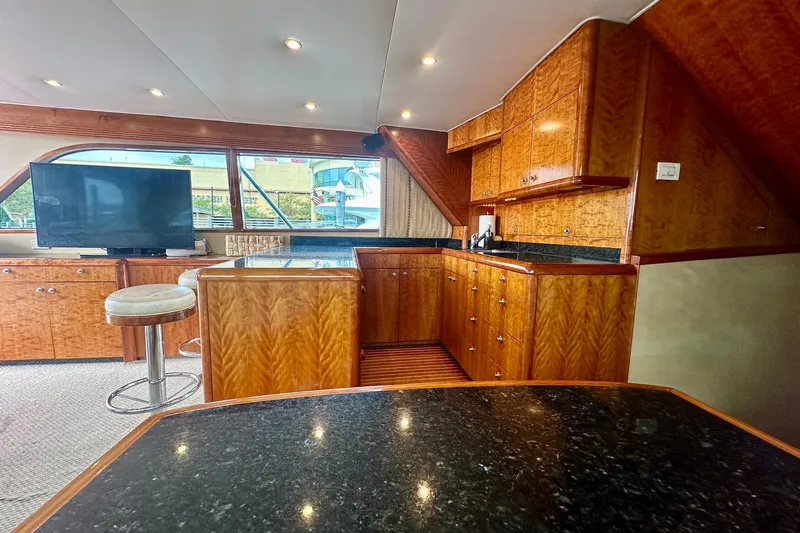 Euphoria Yacht Photos Pics Luxurious interior of 2000 Custom Carolina Precision Sportfish with wood cabinetry and modern amenities.