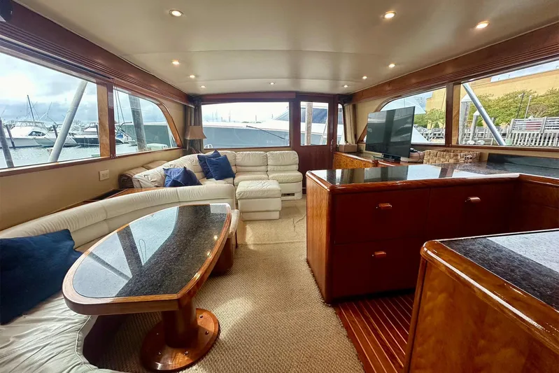 Euphoria Yacht Photos Pics Luxurious interior of 2000 Custom Carolina Precision Sportfish yacht with plush seating and elegant wood finishes.