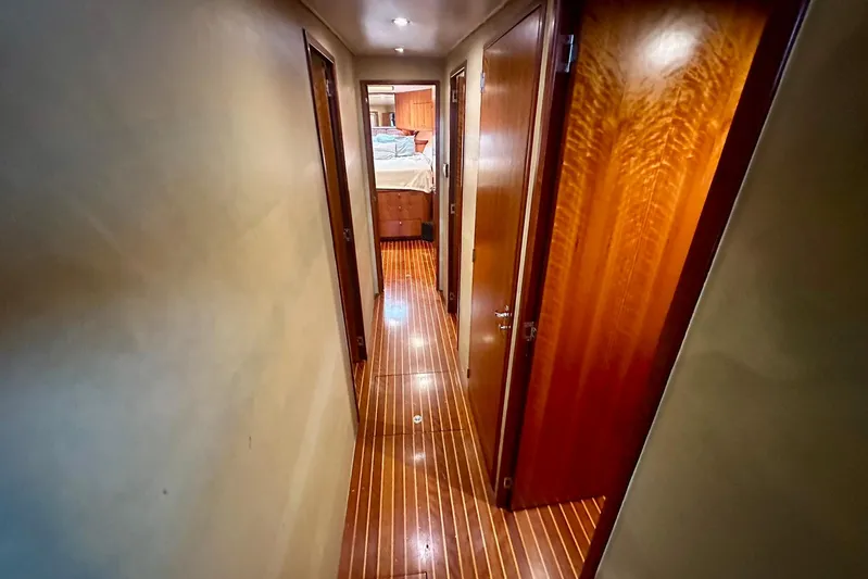 Euphoria Yacht Photos Pics Hallway inside 2000 Custom Carolina Precision Sportfish yacht with wooden flooring and doors.