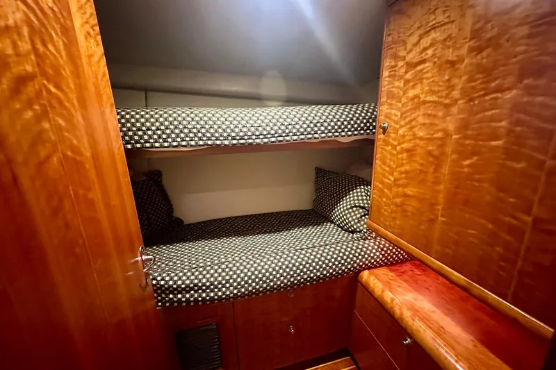 Euphoria Yacht Photos Pics Interior of 2000 Custom Carolina Precision Sportfish with wooden bunk beds and checkered bedding.