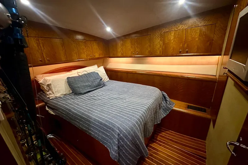 Euphoria Yacht Photos Pics Luxurious cabin interior of 2000 Custom Carolina Precision Sportfish with wood paneling and cozy bedding.