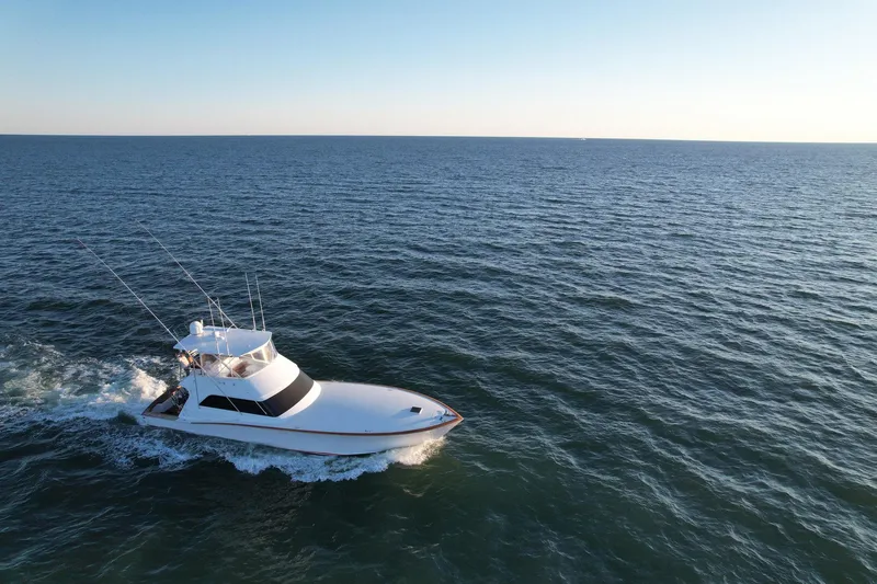 Euphoria Yacht Photos Pics Custom Carolina Precision Sportfish 2000 cruising on open sea under clear sky.