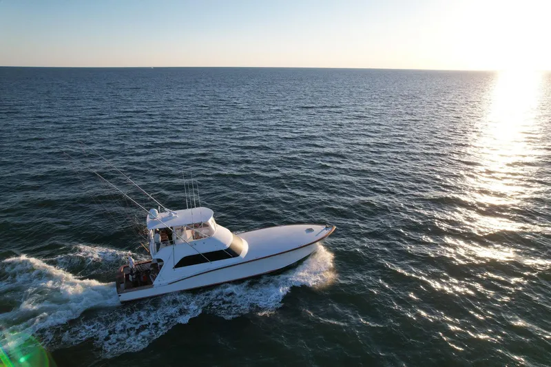 Euphoria Yacht Photos Pics Custom Carolina Precision Sportfish 2000 cruising on open sea at sunset.