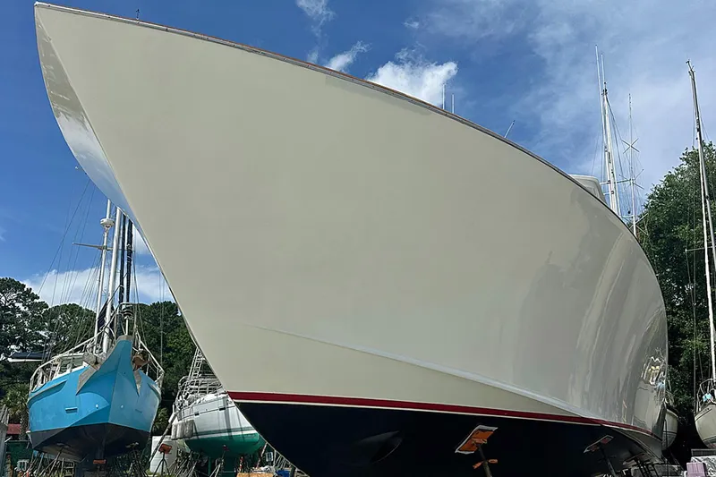 Euphoria Yacht Photos Pics 2000 Custom Carolina Precision Sportfish boat on land, with clear blue sky background.