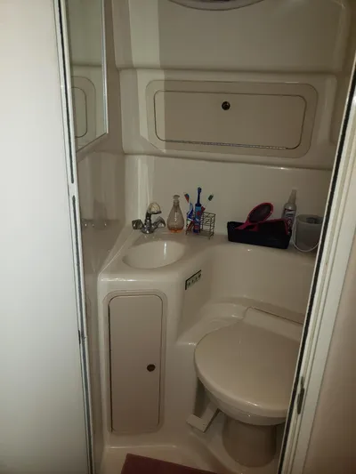 Escondite Yacht Photos Pics Compact bathroom in 2001 Sea Ray 410 Sundancer yacht, featuring sink and toilet.