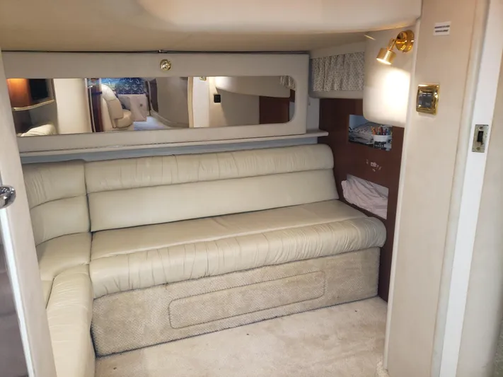 Escondite Yacht Photos Pics Interior of 2001 Sea Ray 410 Sundancer with beige leather seating and wall mirror.
