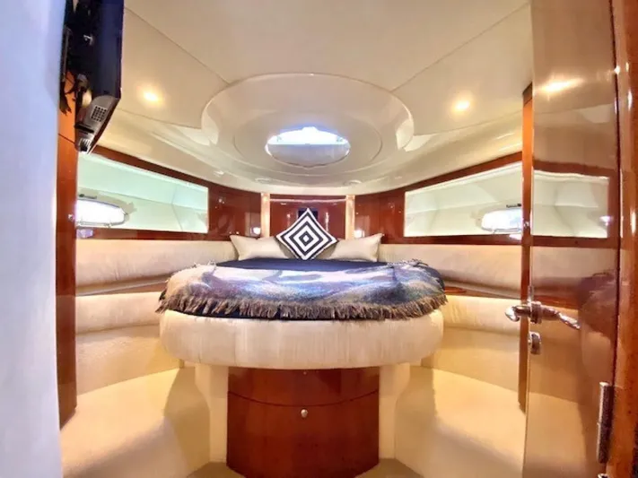 Mahalo Yacht Photos Pics Luxurious cabin interior of 2007 Fairline Targa 52 yacht with elegant bedding and wood finishes.