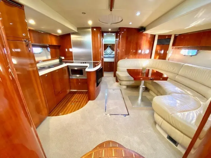 Mahalo Yacht Photos Pics Luxurious interior of 2007 Fairline Targa 52 yacht with kitchen and seating area.