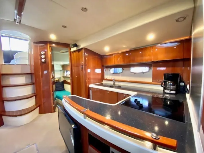 Mahalo Yacht Photos Pics Luxurious interior of 2007 Fairline Targa 52 yacht with modern kitchen amenities.