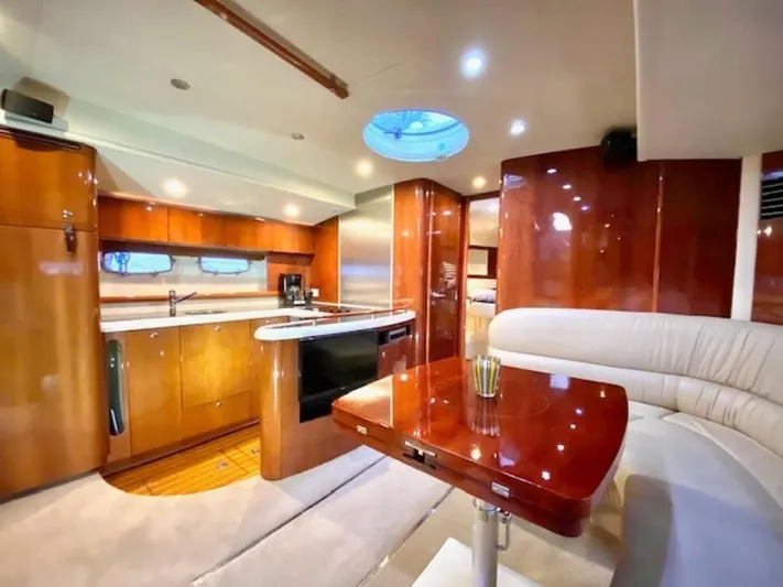 Mahalo Yacht Photos Pics Luxurious interior of 2007 Fairline Targa 52 yacht with modern kitchen and seating area.