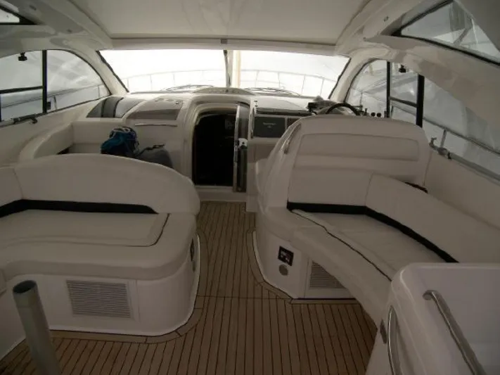 Mahalo Yacht Photos Pics Interior of 2007 Fairline Targa 52 yacht with sleek white seating and wooden flooring.