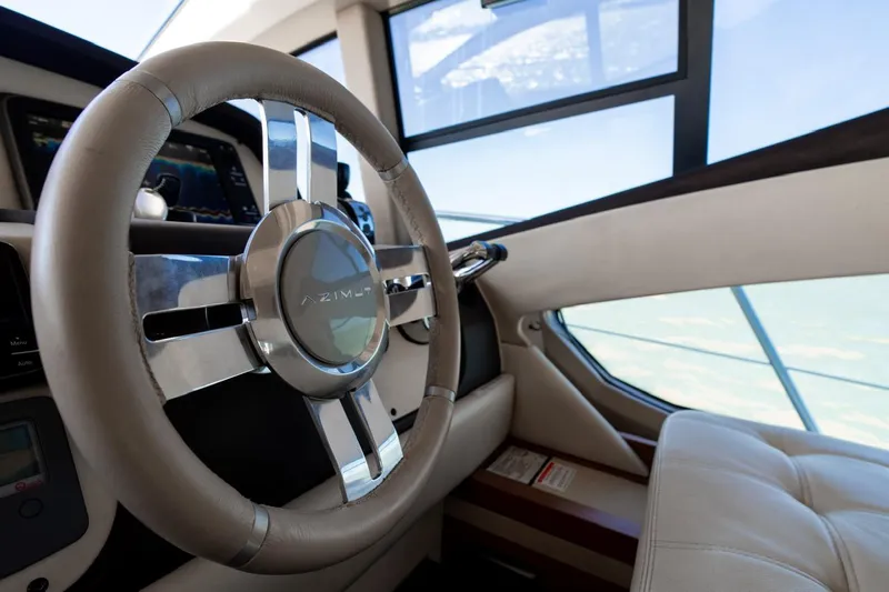 Seanner Yacht Photos Pics Steering wheel of 2014 Azimut 45 Flybridge yacht, showcasing modern design and luxury interior.