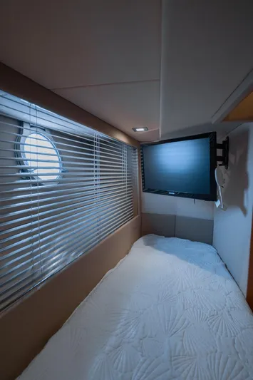 Seanner Yacht Photos Pics Interior cabin of 2014 Azimut 45 Flybridge yacht with bed, window blinds, and wall-mounted TV.