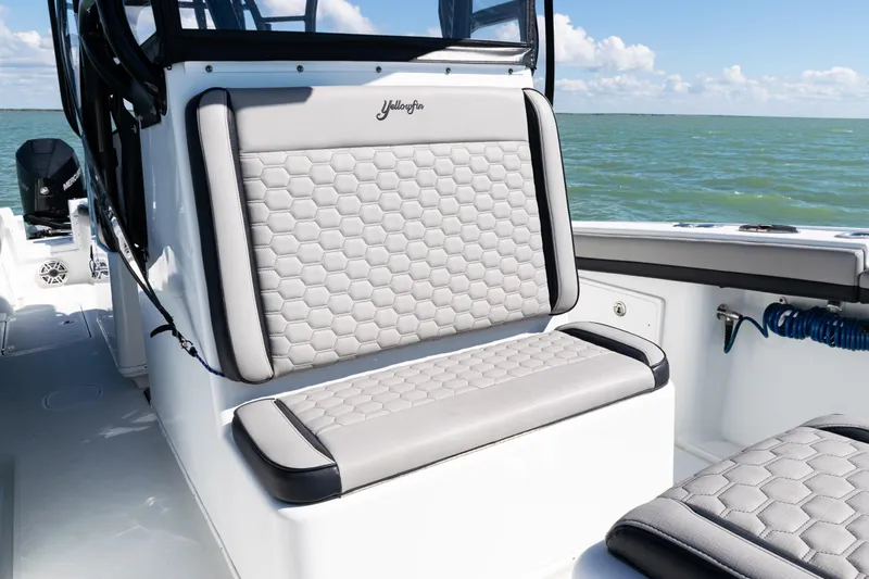  Yacht Photos Pics 2019 Yellowfin 36 Offshore boat with cushioned seating, on a sunny day at sea.