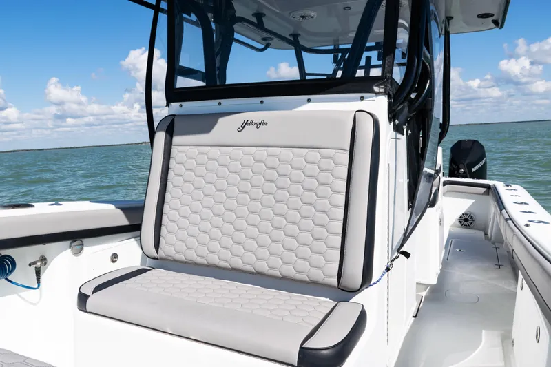  Yacht Photos Pics 2019 Yellowfin 36 Offshore boat interior with cushioned seating, on a sunny day at sea.