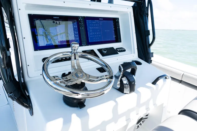  Yacht Photos Pics 2019 Yellowfin 36 Offshore boat dashboard with dual Simrad displays and chrome steering wheel.