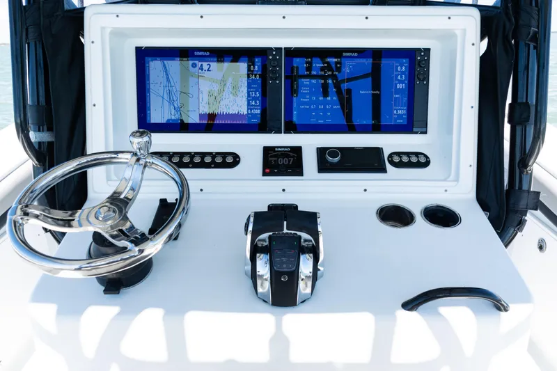 Yacht Photos Pics 2019 Yellowfin 36 Offshore boat dashboard with dual Simrad displays and steering wheel.