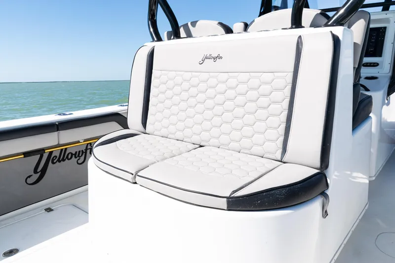  Yacht Photos Pics 2019 Yellowfin 36 Offshore boat with hexagonal-patterned seating, ocean backdrop.