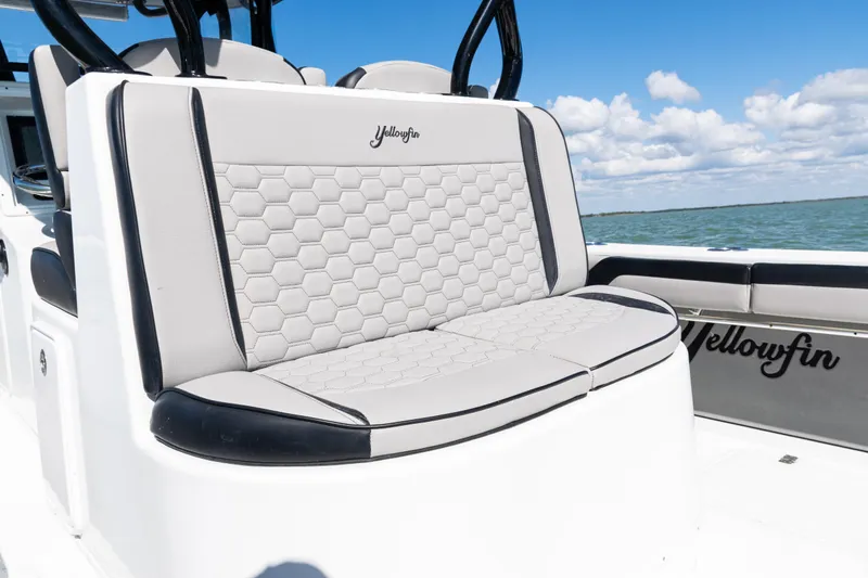  Yacht Photos Pics 2019 Yellowfin 36 Offshore boat with hexagonal-patterned seating, ocean backdrop.