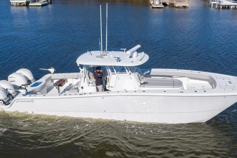  Yacht Photos Pics 2024 Freeman 38 boat cruising on calm waters with dual Yamaha engines.