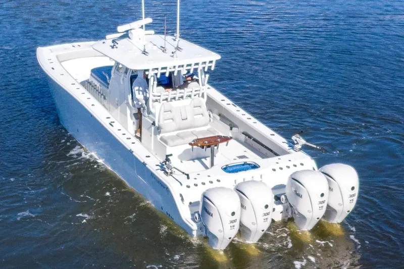  Yacht Photos Pics 2024 Freeman 38 boat with four outboard engines cruising on water.