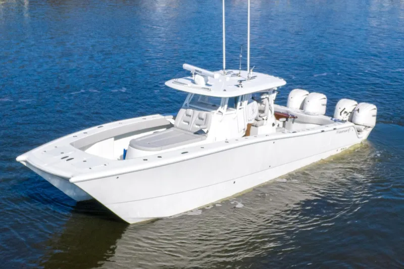  Yacht Photos Pics 2024 Freeman 38 boat on water, featuring sleek design and multiple outboard engines.