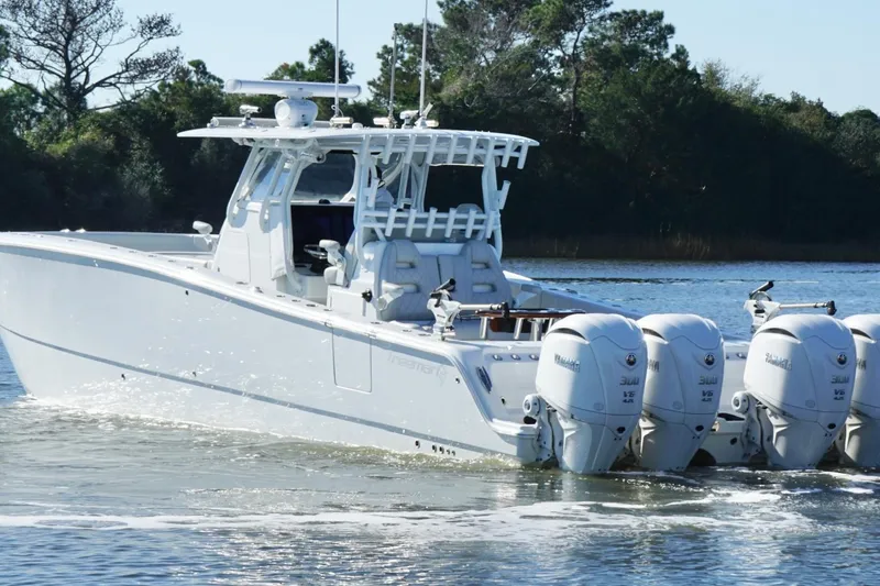  Yacht Photos Pics 2024 Freeman 38 boat with four Yamaha engines cruising on a calm lake.