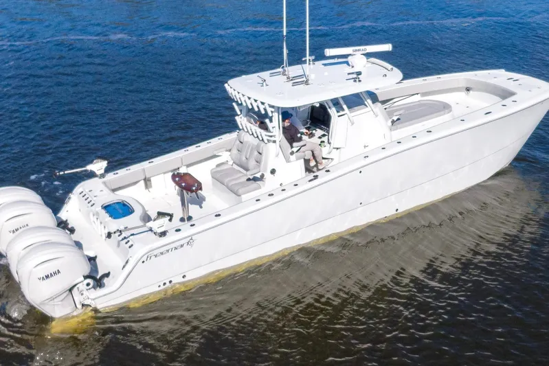  Yacht Photos Pics 2024 Freeman 38 boat cruising on water with multiple Yamaha engines.