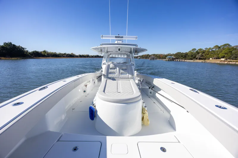  Yacht Photos Pics 2024 Freeman 38 boat on calm water, showcasing spacious deck and seating.