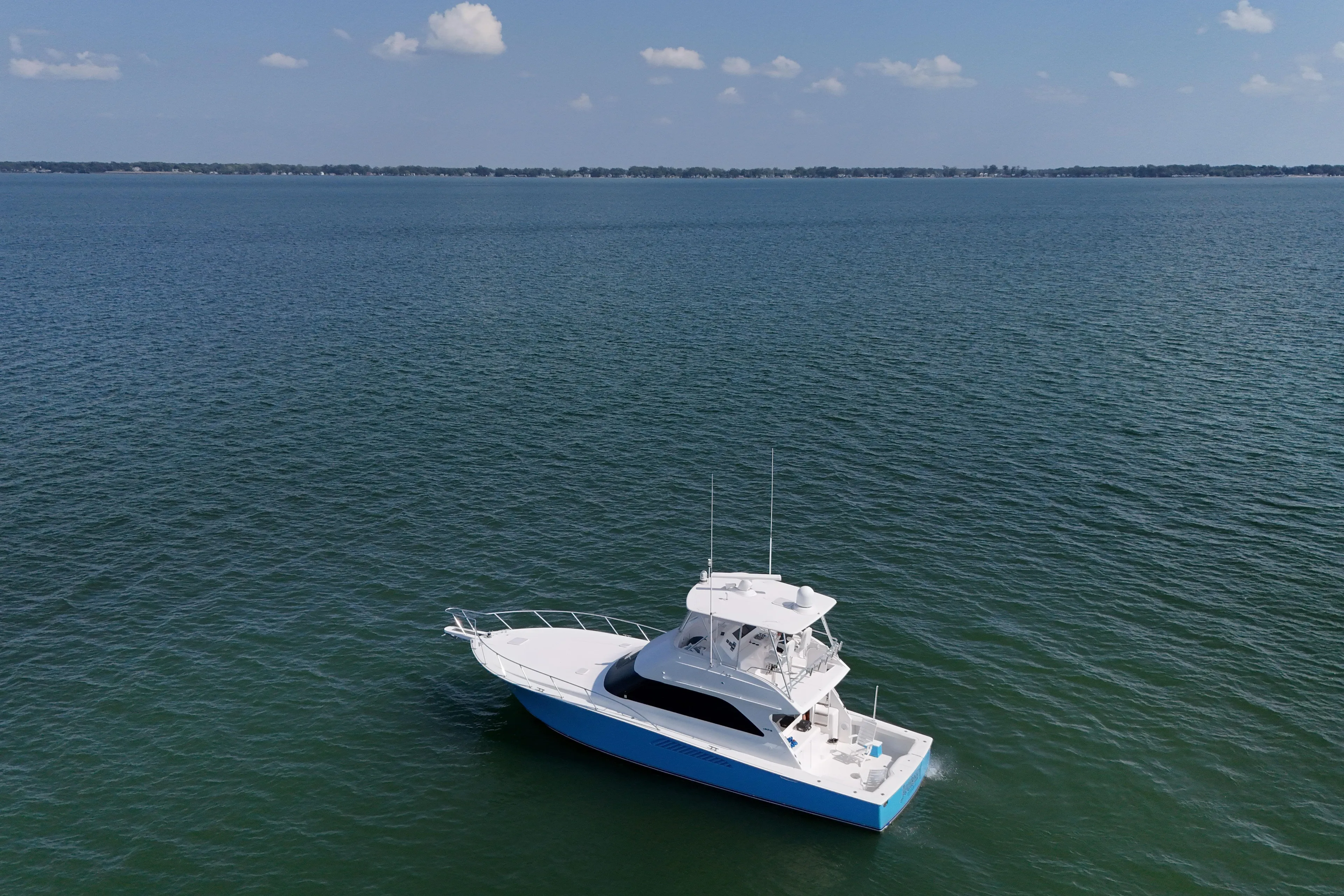 Journey Yacht Photos Pics 2003 Viking 48 Convertible yacht on open water under clear sky.