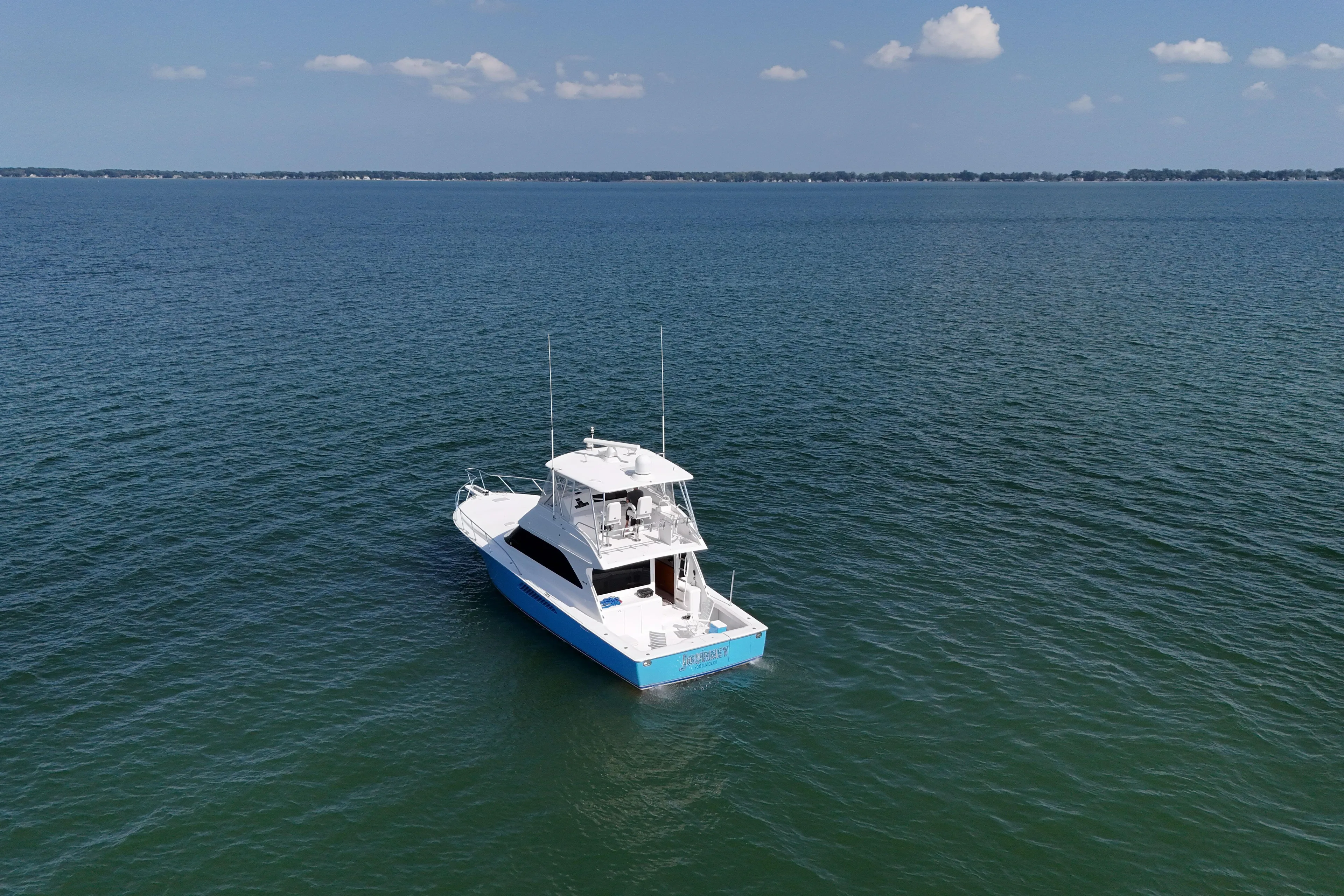 Journey Yacht Photos Pics 2003 Viking 48 Convertible yacht on open water under clear blue sky.