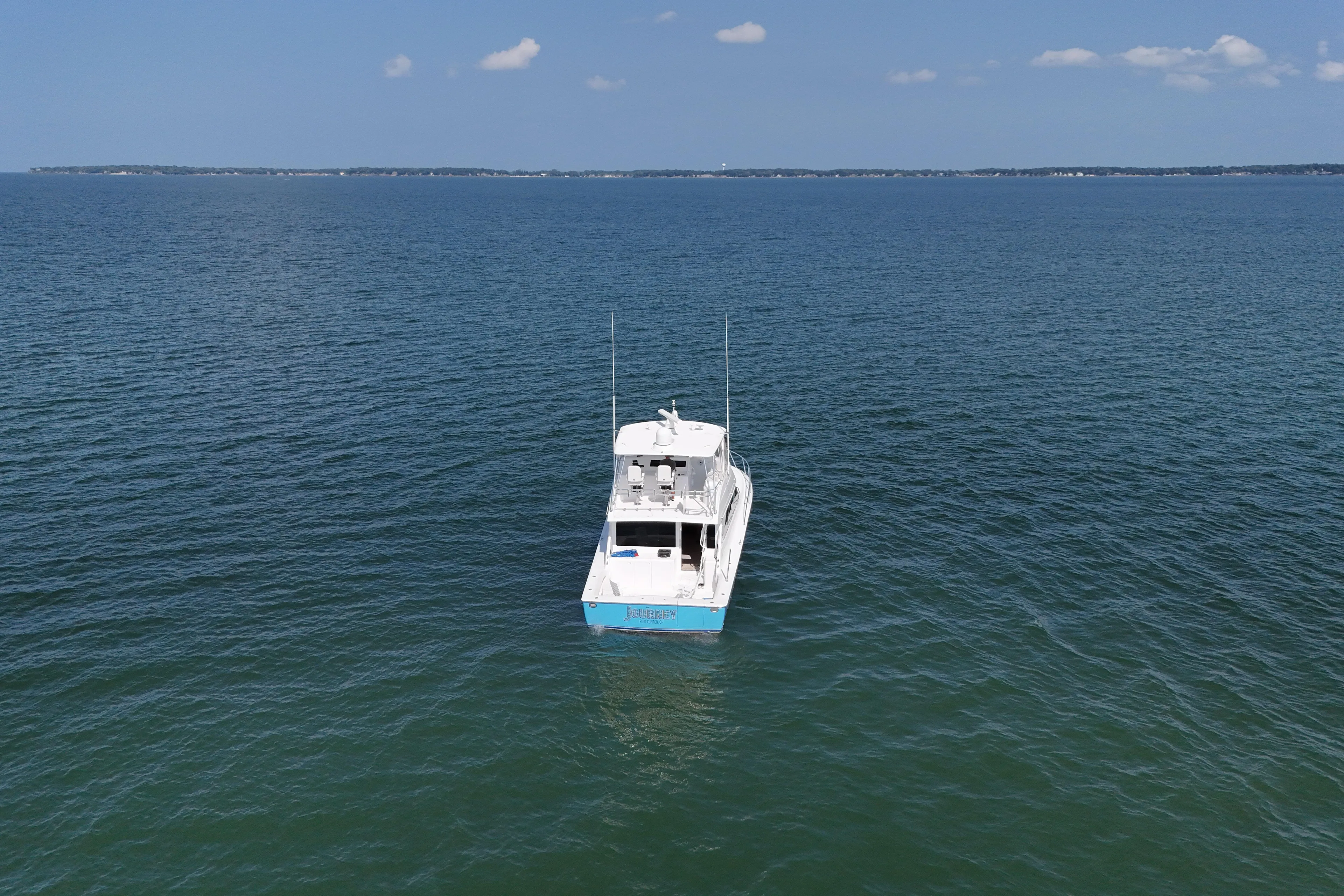 Journey Yacht Photos Pics 2003 Viking 48 Convertible yacht on open sea under clear sky.