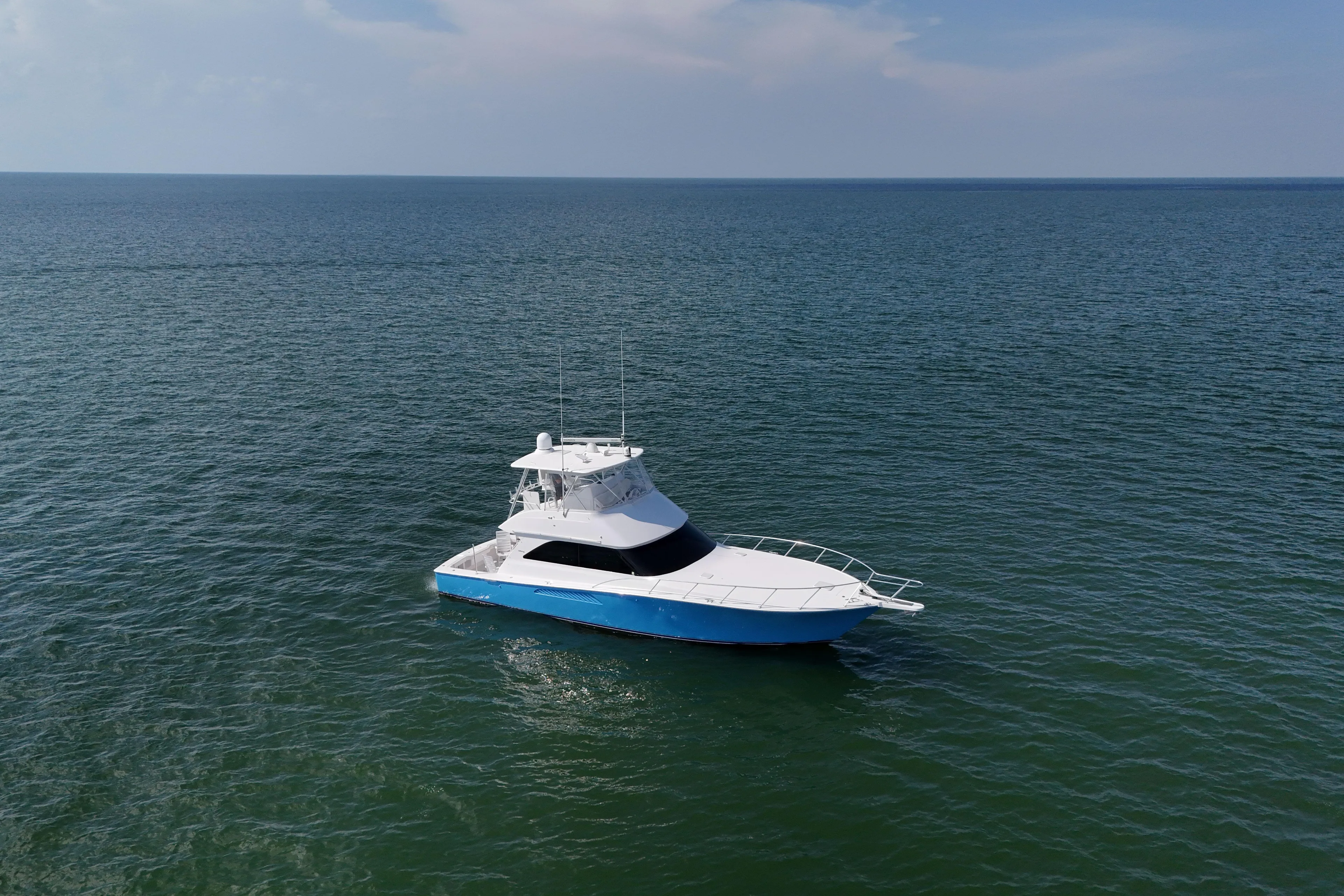 Journey Yacht Photos Pics 2003 Viking 48 Convertible yacht cruising on open sea under clear sky.