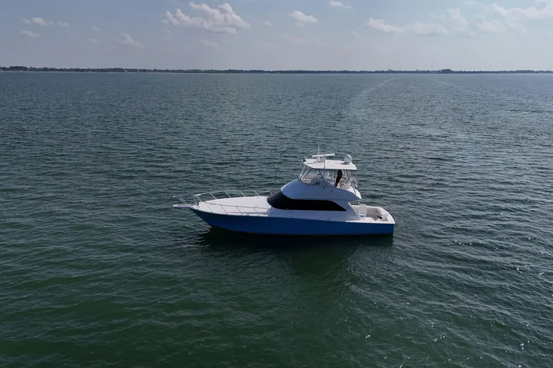 Journey Yacht Photos Pics 2003 Viking 48 Convertible yacht cruising on open water under a clear sky.