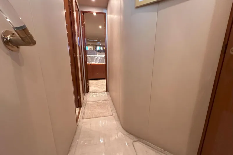 Journey Yacht Photos Pics Narrow hallway inside 2003 Viking 48 Convertible yacht, featuring elegant wood finishes and soft lighting.