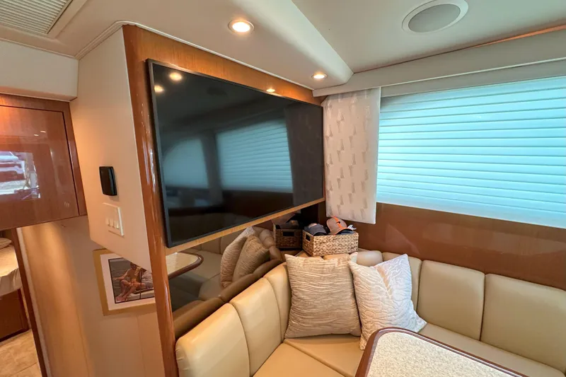 Journey Yacht Photos Pics Interior of 2003 Viking 48 Convertible yacht with TV, seating, and decor.