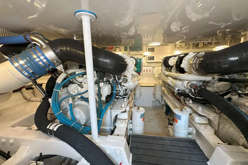 Journey Yacht Photos Pics Engine room of a 2003 Viking 48 Convertible yacht, showcasing dual engines and piping.