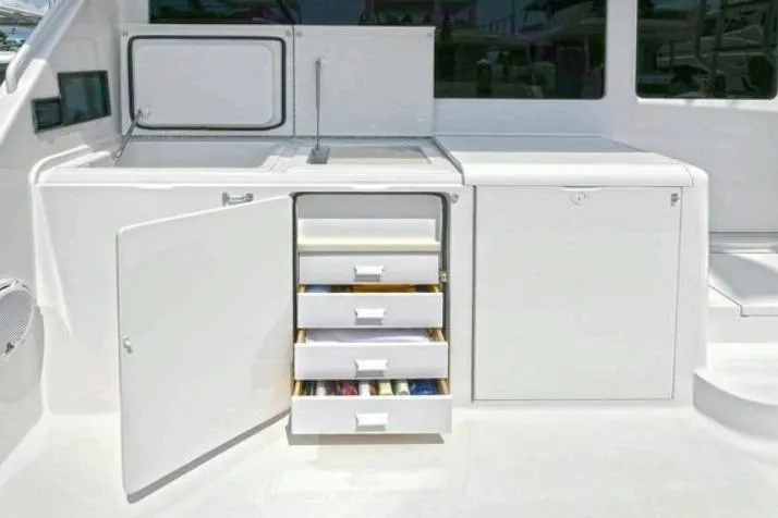 Journey Yacht Photos Pics 2003 Viking 48 Convertible yacht interior with open storage drawers and cabinets.