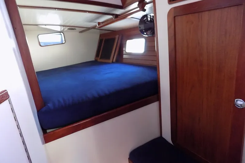  Yacht Photos Pics Cozy cabin interior of 2014 Custom Aluminum Expedition boat with wooden accents and blue bedding.