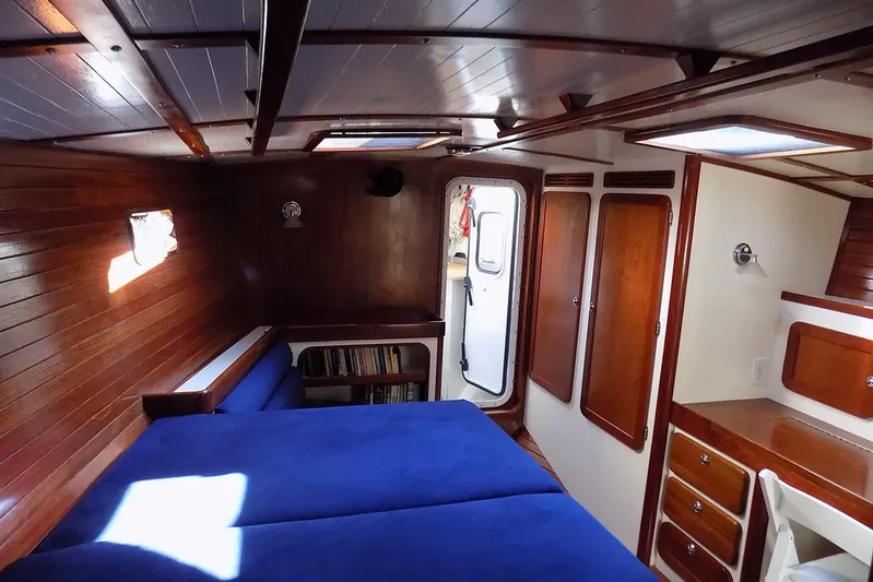  Yacht Photos Pics Cozy cabin interior of 2014 Custom Aluminum Expedition boat with wooden paneling and blue bedding.
