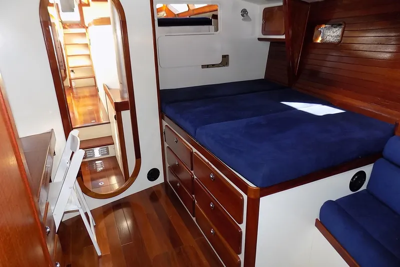 Yacht Photos Pics Cozy cabin interior of 2014 Custom Aluminum Expedition yacht with blue bedding and wooden accents.