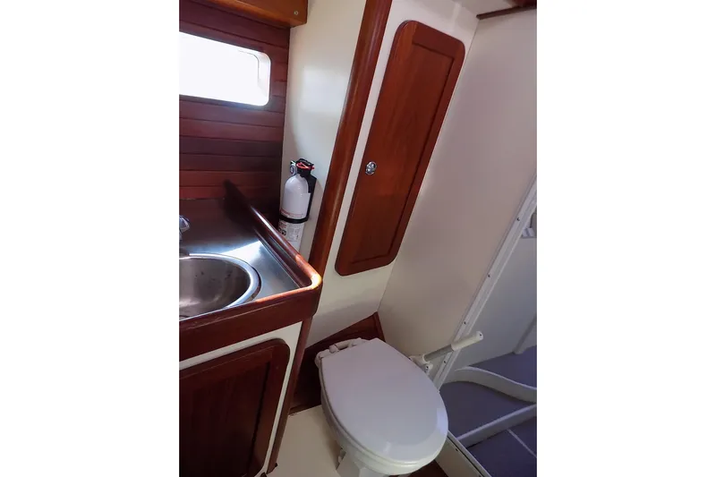  Yacht Photos Pics Compact bathroom in 2014 Custom Aluminum Expedition boat with wooden accents and stainless steel sink.