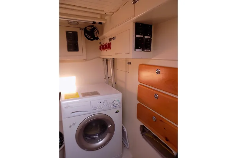  Yacht Photos Pics Laundry area in 2014 Custom Aluminum Expedition with washer, storage drawers, and electrical panels.