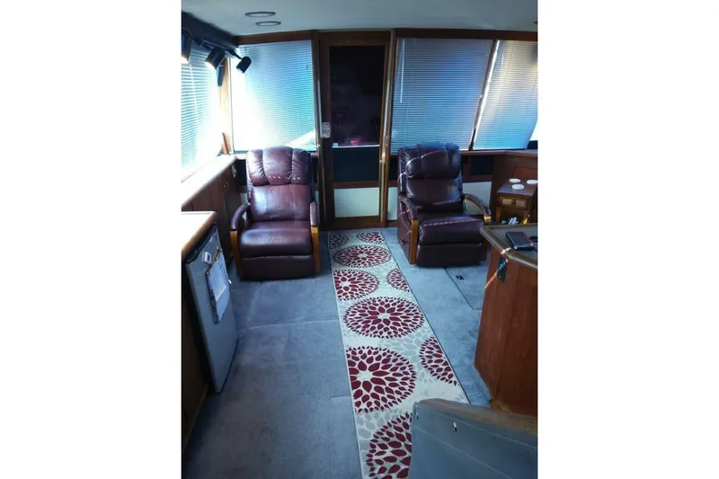  Yacht Photos Pics Interior of 1991 Bayliner 4588 Pilothouse with leather chairs and patterned rug.