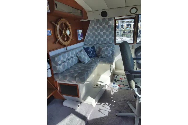  Yacht Photos Pics Interior of 1991 Bayliner 4588 Pilothouse with geometric seating and nautical decor.