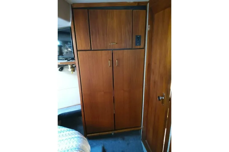  Yacht Photos Pics 1991 Bayliner 4588 Pilothouse interior with wooden cabinetry and door.