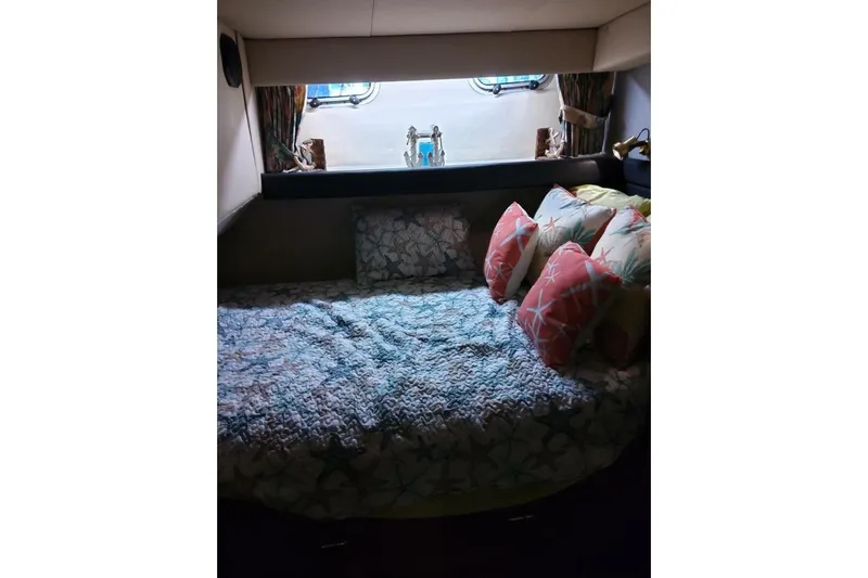  Yacht Photos Pics Cozy cabin interior of 1991 Bayliner 4588 Pilothouse with decorative pillows and bedding.