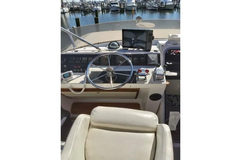  Yacht Photos Pics 1991 Bayliner 4588 Pilothouse helm with steering wheel and navigation equipment.
